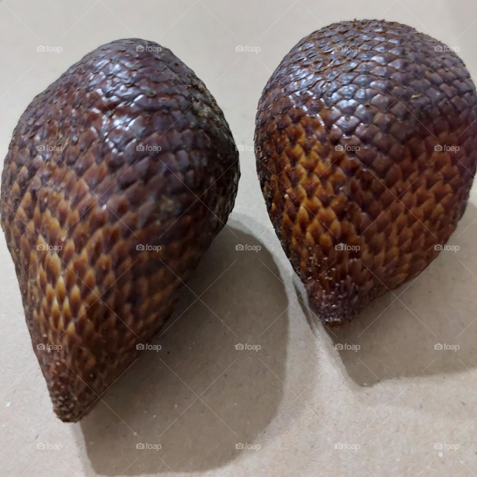 Freshly picked salak fruit from the tree. scaly fruit skin texture like snake skin