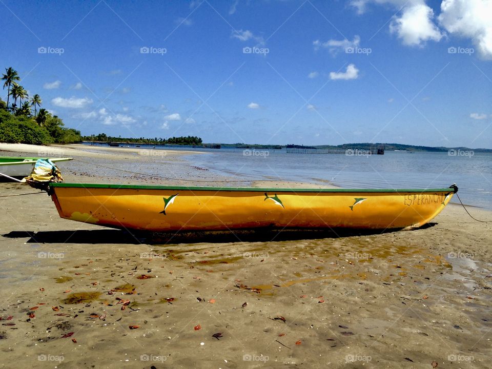 yellow canoe on the beach in Taipu de Fora, Bahia, Brazil 