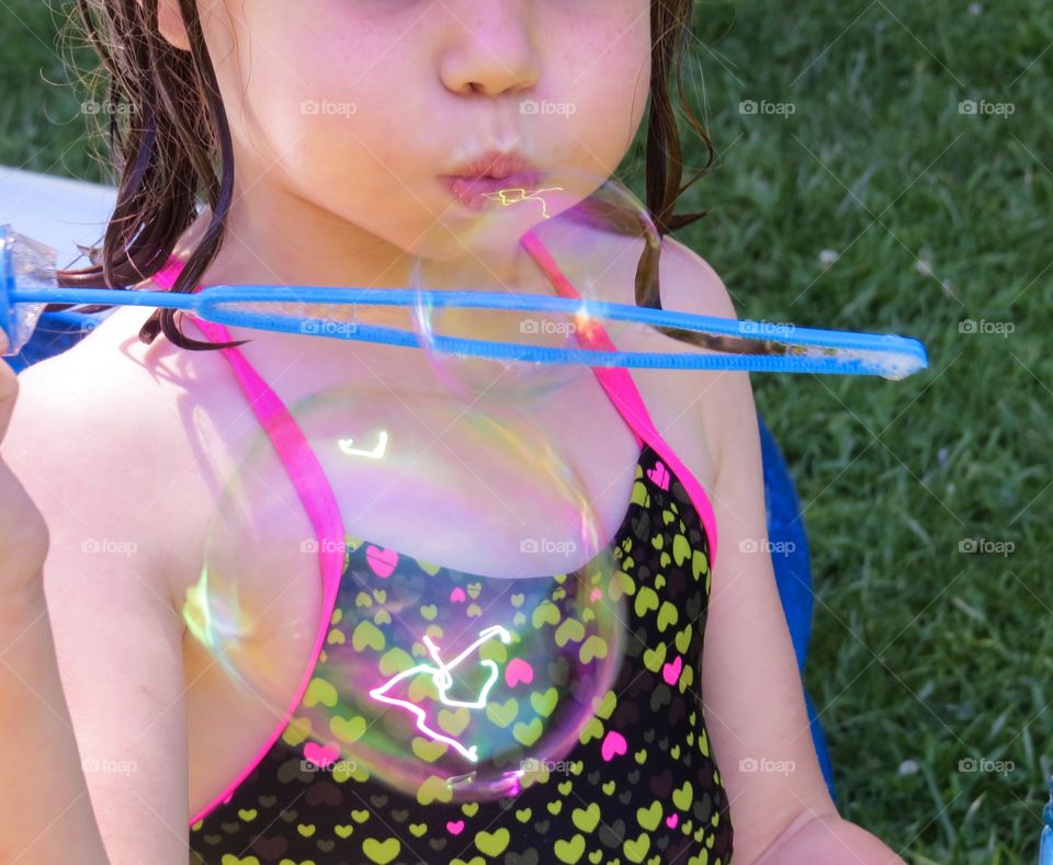 Child blowing bubbles.