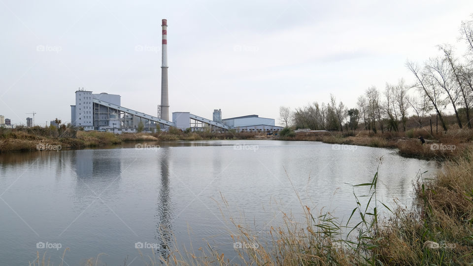 the factory near the lake in autumn