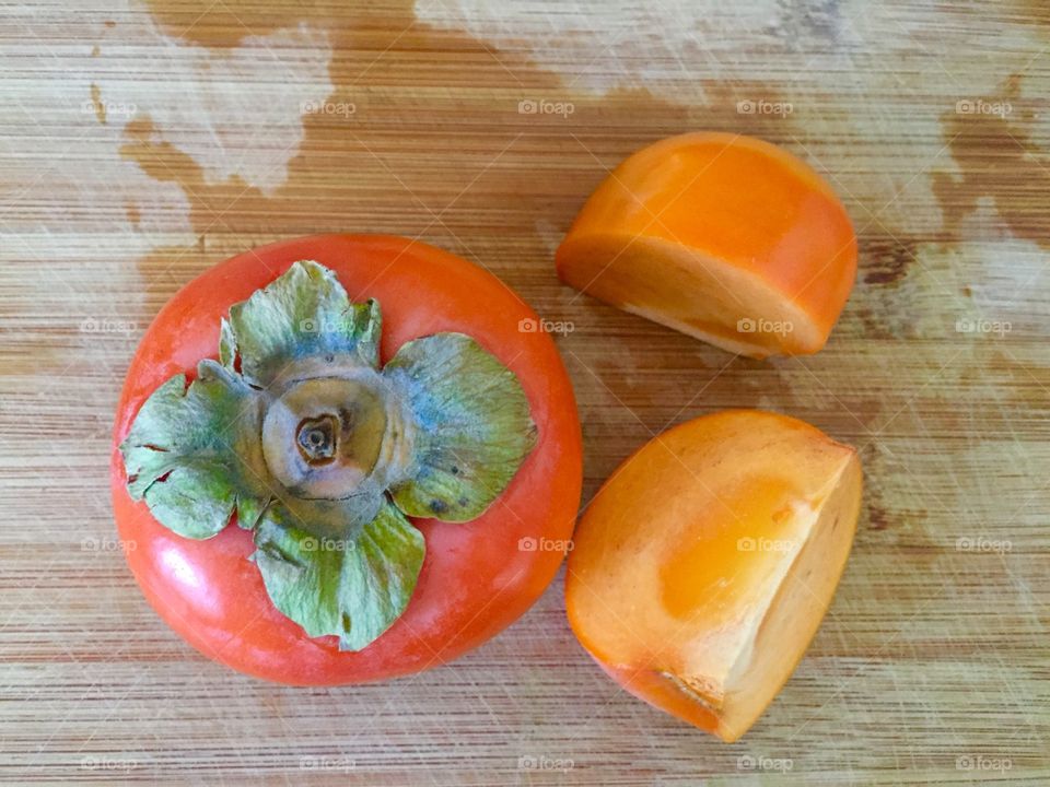 Persimmon on bamboo board 