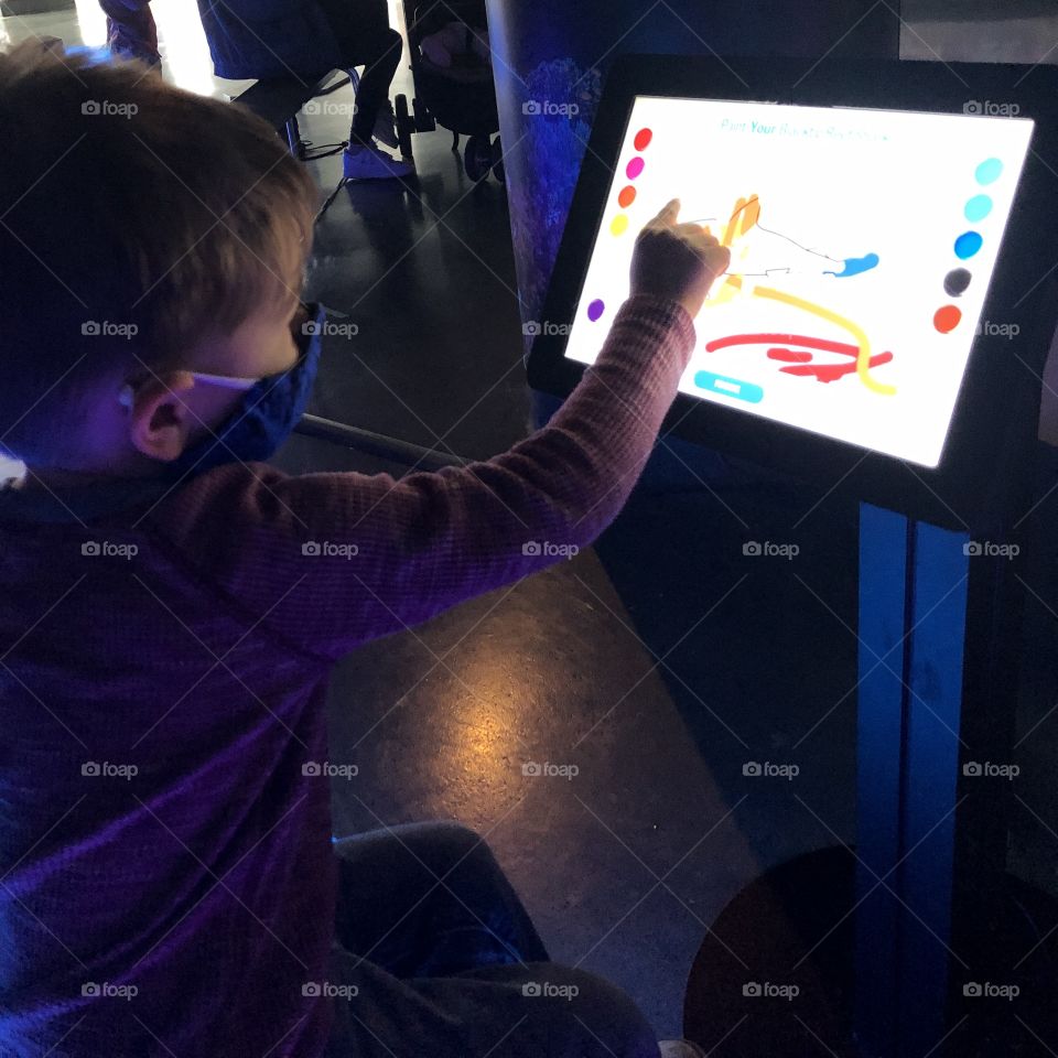 Toddler paints a virtual fish