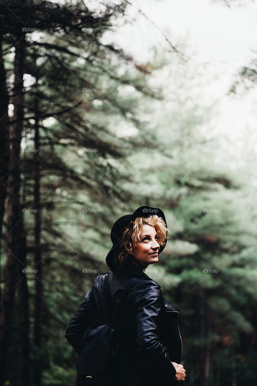 Close-up of a mid adult woman standing in forest