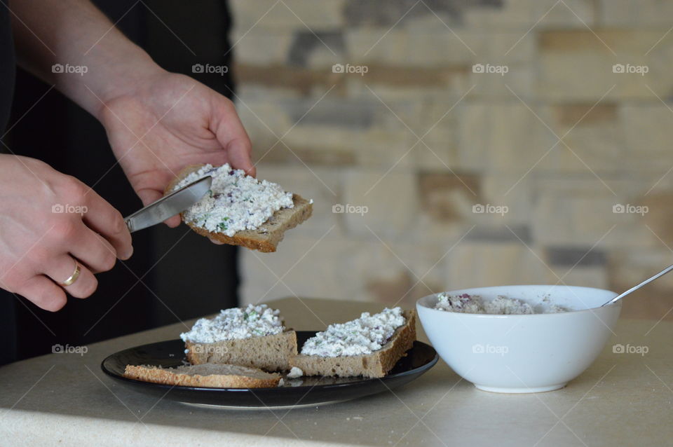 Close-up of a person preparing sandwiches