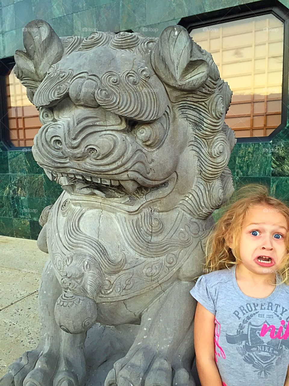 Girl standing near the Guardian Lion guard