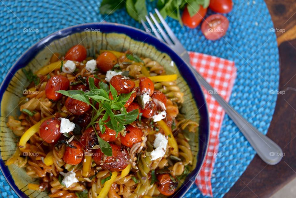 Garnished pasta dish on table