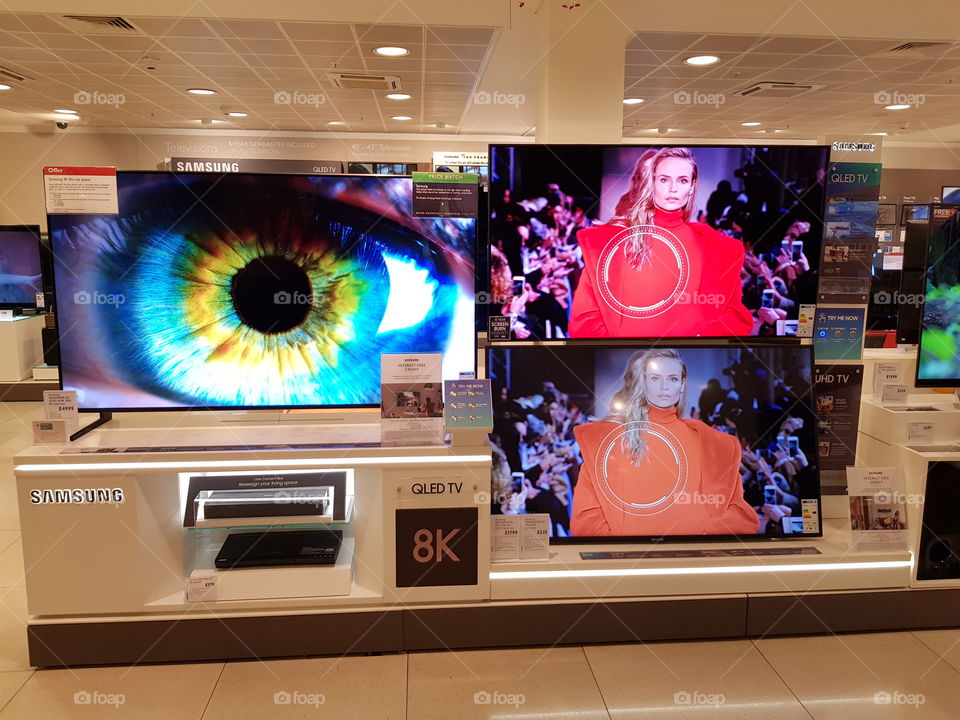 Samsung 8K QLED television blue eyes demo on QLED television and comparison wall with model