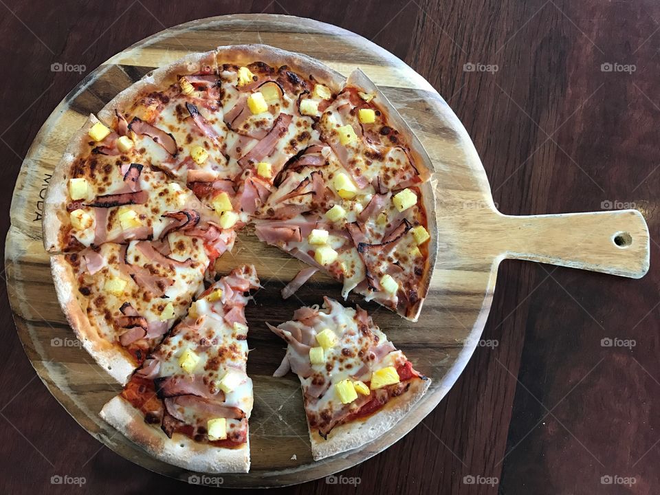Hawaii pizza on a wooden board