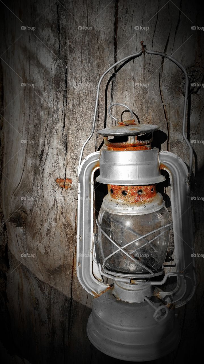 Old lamp hanging on wooden wall