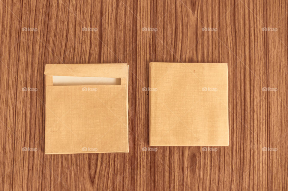 Set of two Brown envelope front and back isolated on wooden table hardwood floor background. Business cards blank. Mockup. Top high angel view object with clipping path. Flat Lay. Copy space for text