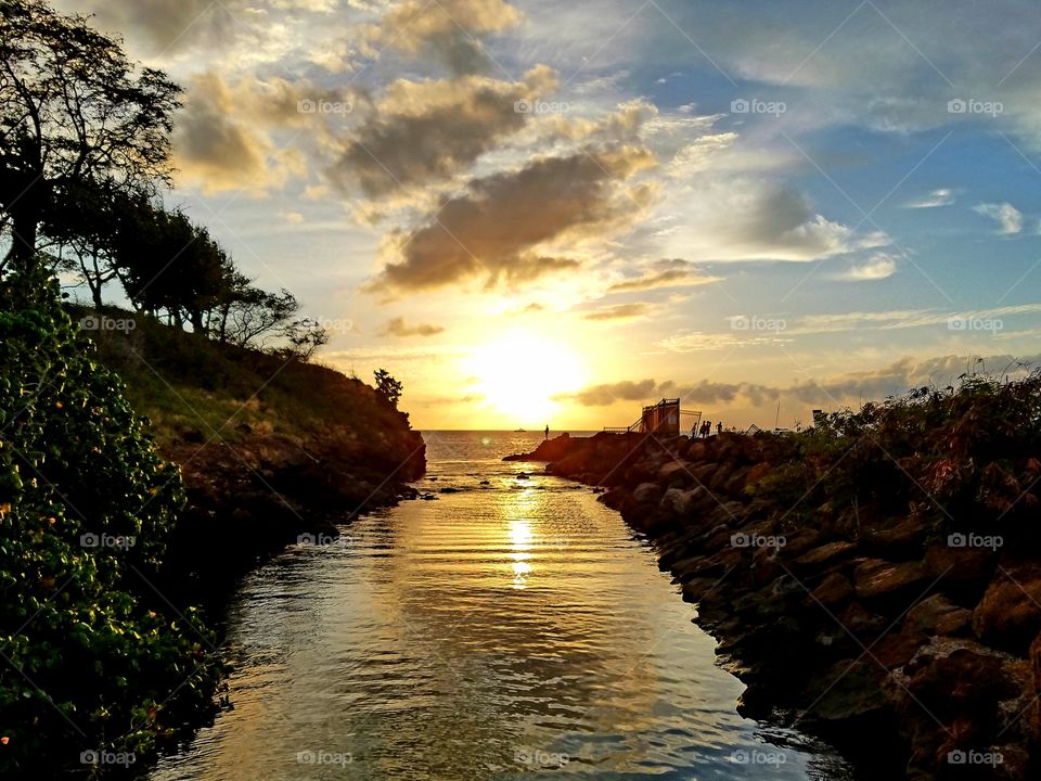 Creek meet the ocean at sunset