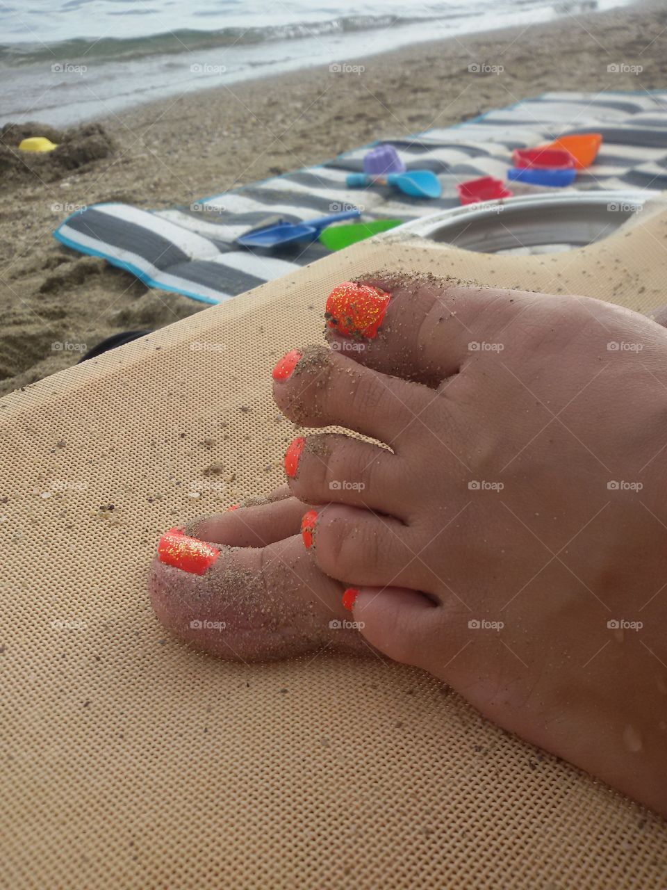 Female feet on the beach