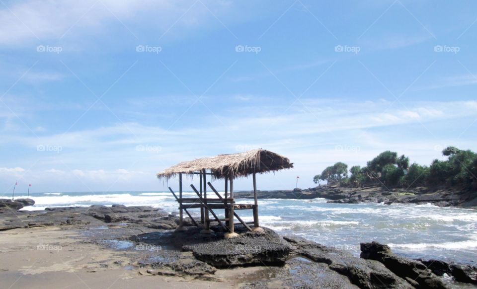 blue sky with rocks waves