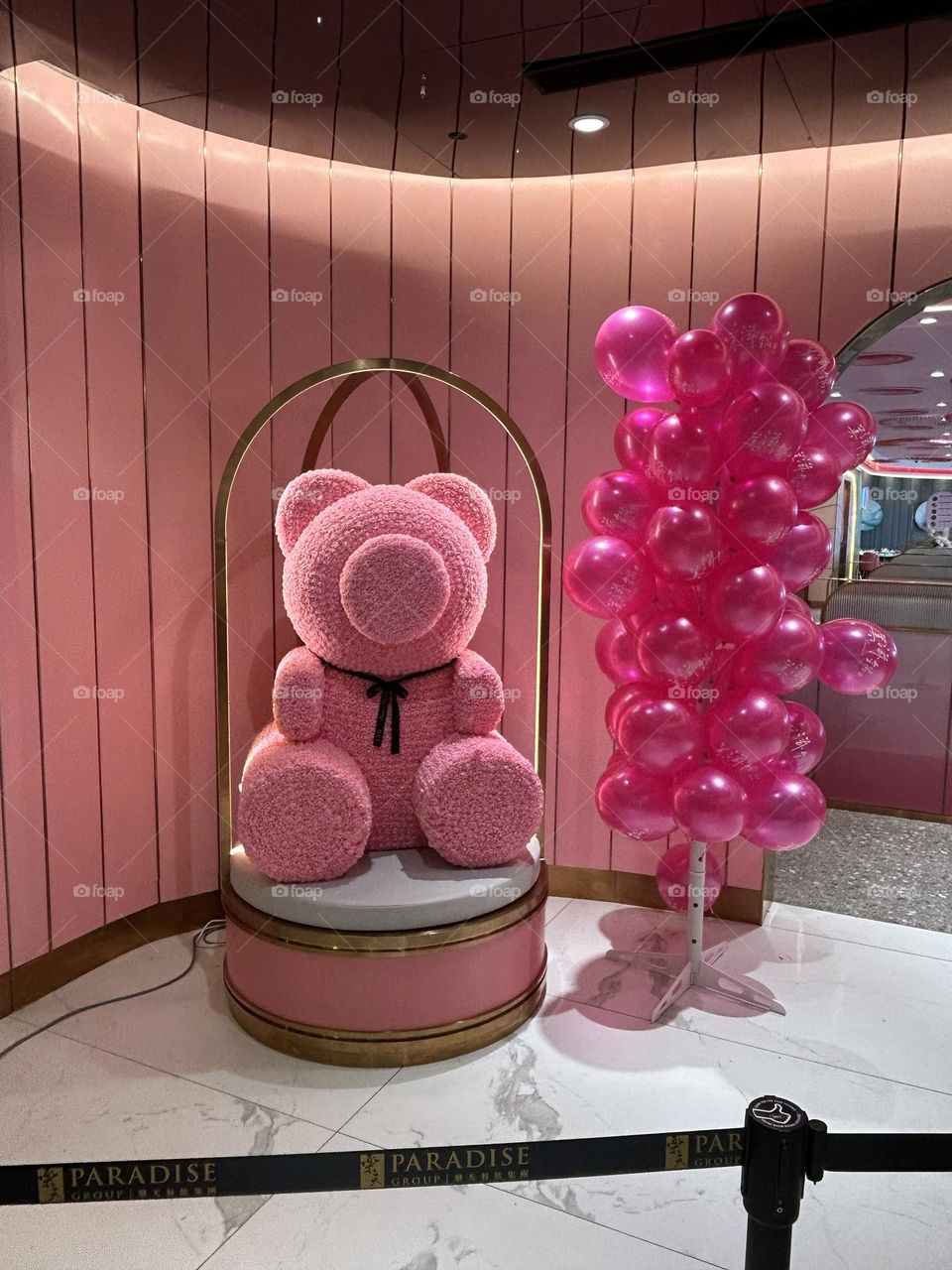 The pinkTeddy bear with pink balloons at front Restaurant Beauty in the Pot in the mall