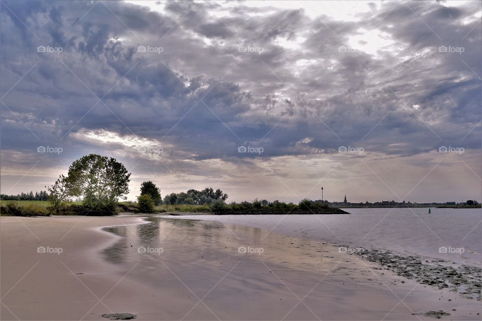 Sunset at the river shore in The Netherlands