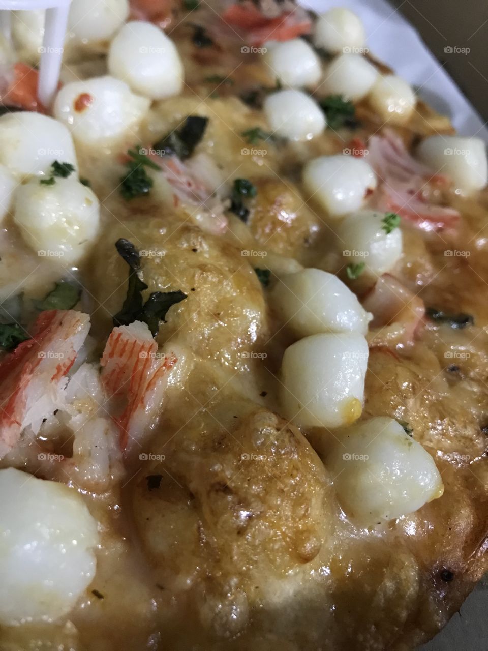 Pizza in a sea of shrimp and scallops. Yum!