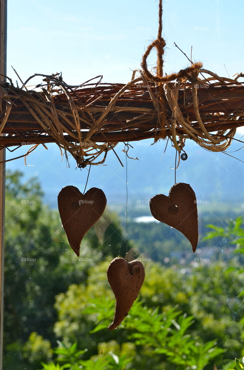 Heart shape handing on wood with rope