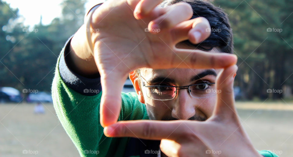 Boy framing with hand