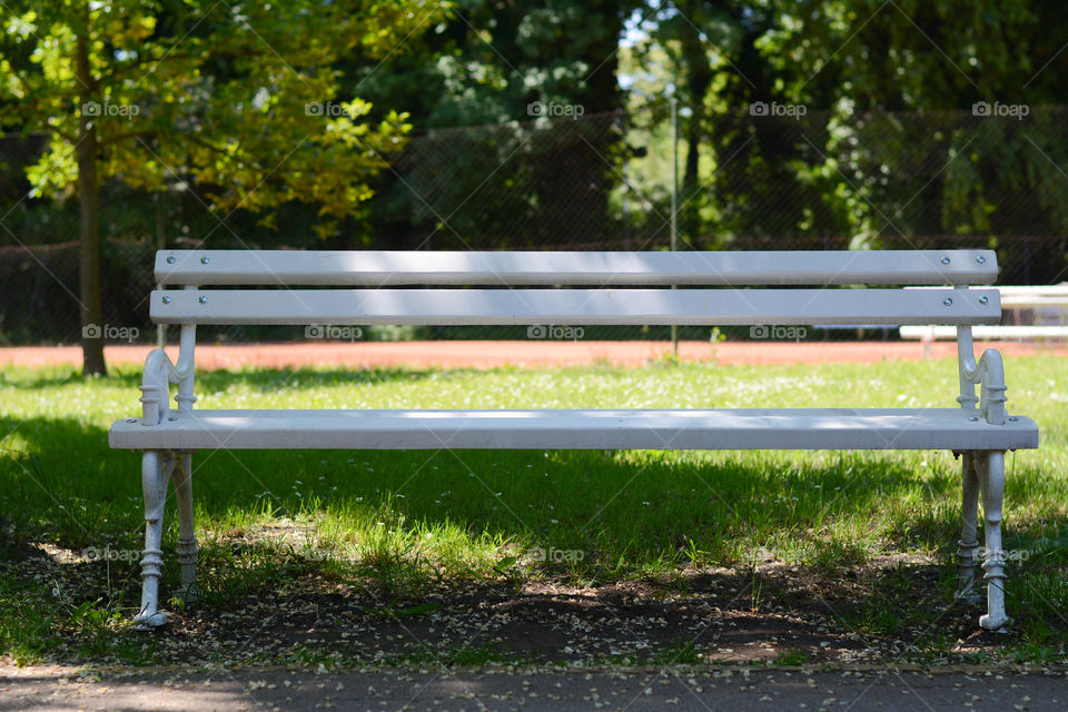 White iron bench in a park. Photographed in park Palic, beautiful nature near Subotica, Serbia