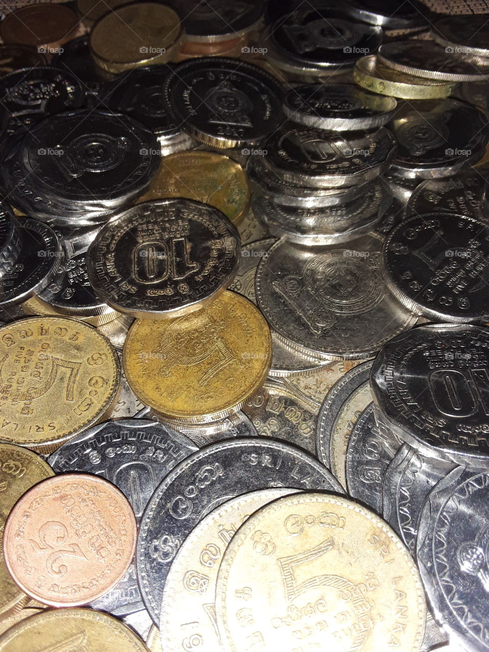 a coins is a small flat (usually depending on the country or value) round piece of metal or plastic used primarily as a medium of exchange or legal tender they are standardized in weight and produced at a mint in order to facilitate trade.