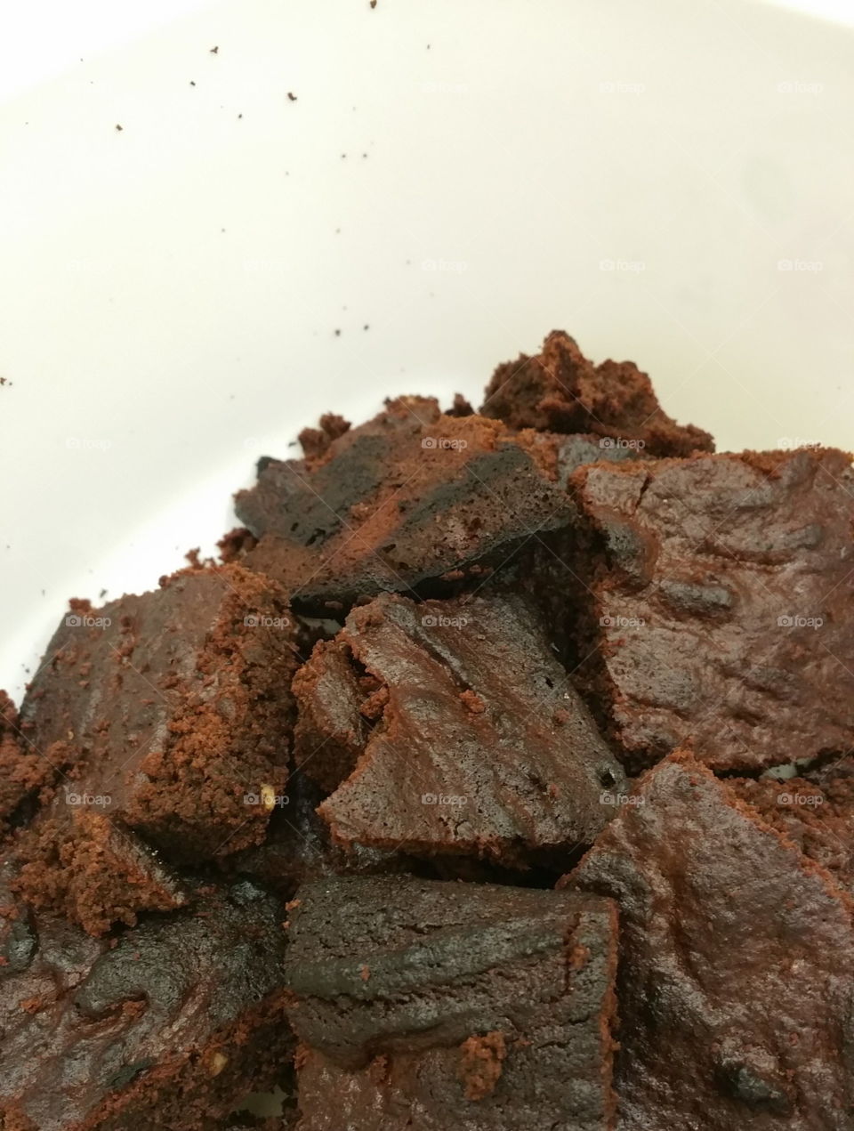 Homemade chocolate flapjacks with white background