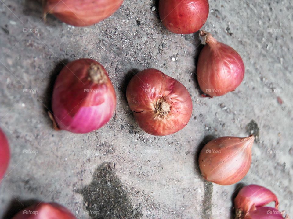 Close-up of raw shallots on the ground