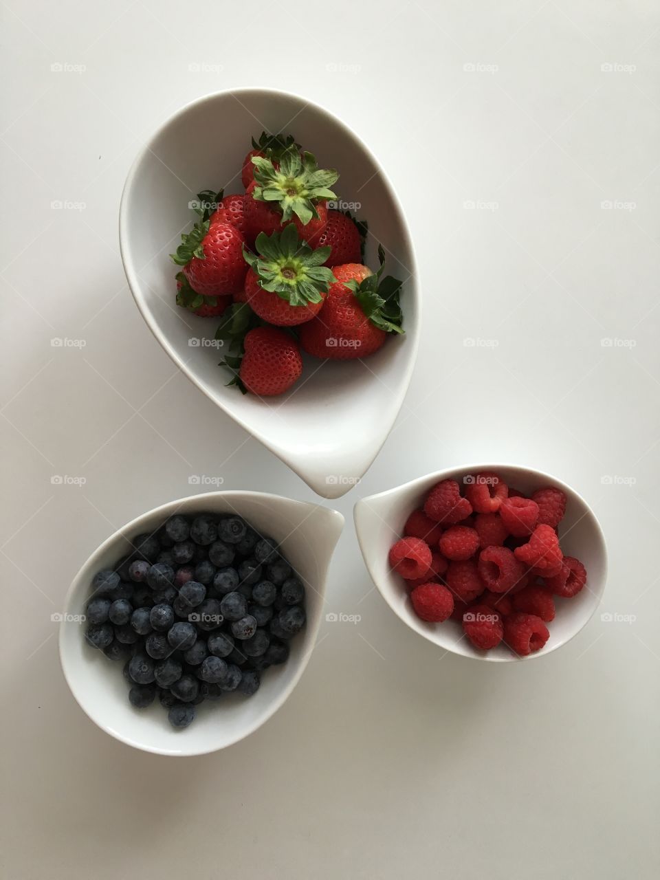 Berries in bowl on white background