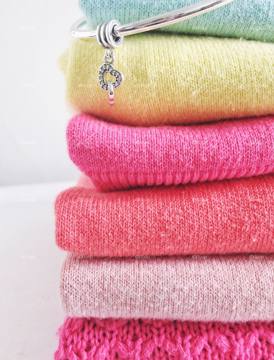 Stacked coloured sweaters 
