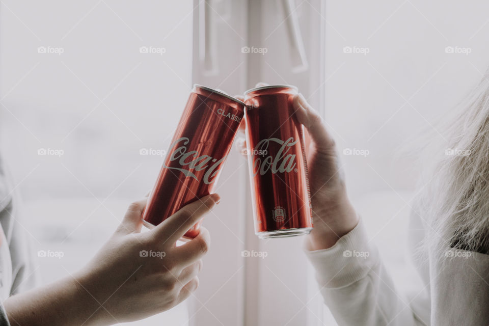 coca cola in hands / cheers with coca cola
