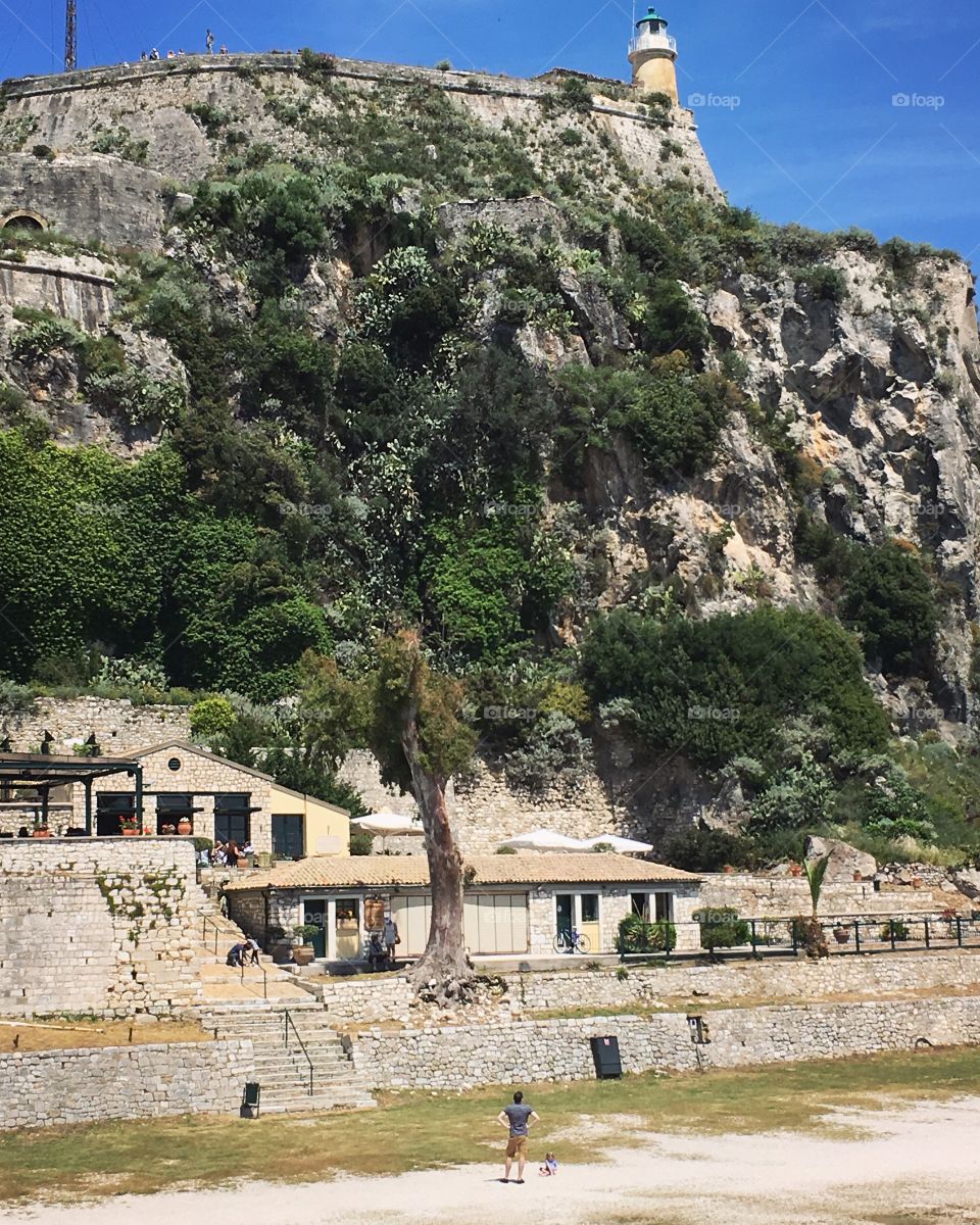 Father and daughter exploring and viewing the Old Fortress in Corfu Town, Greece