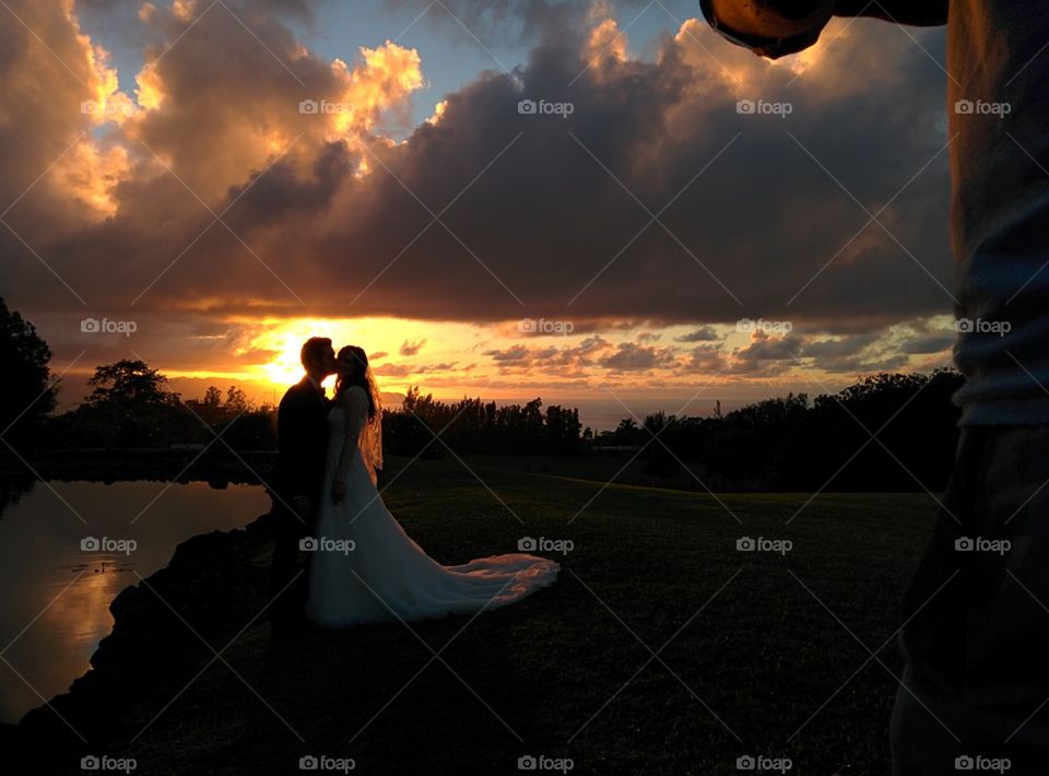 Wedding sunset kiss