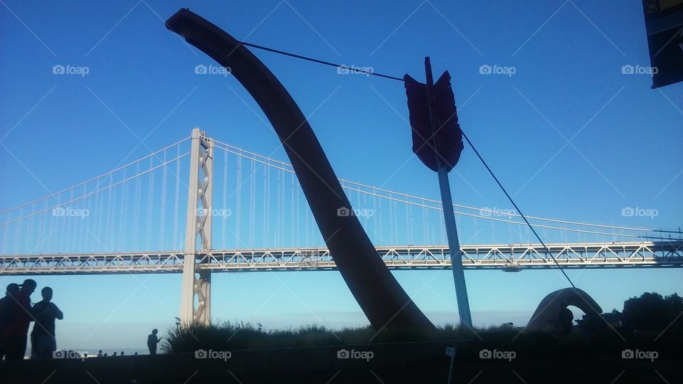 bow and arrow land mark in front of bay bridge