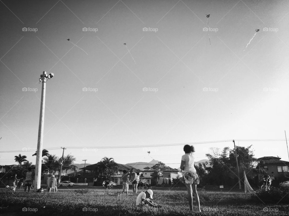 Kite girl . Some children were playing alongside the beach and putting their kites in the sky in Paraty's sky. 