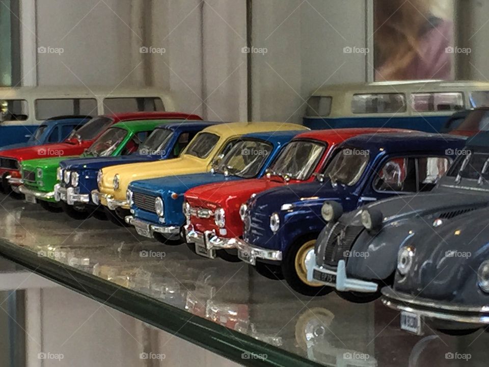 Lots of beautiful colorful model cars in a row