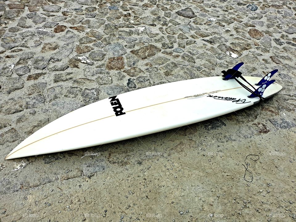 surfboard laying on the ground