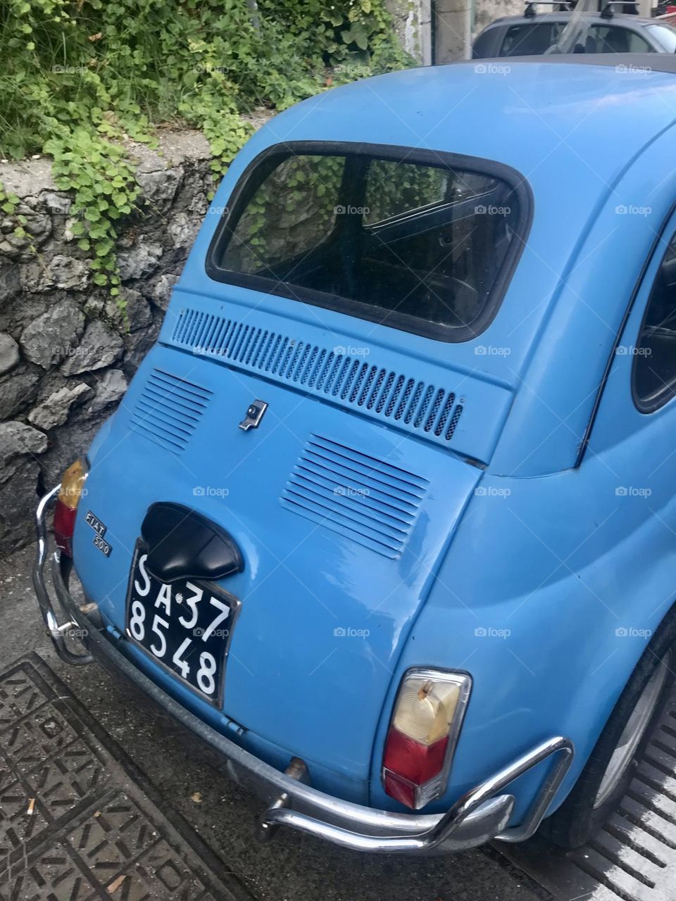 The back end of a classic Fiat 500, parked in Amalfi, Italy.