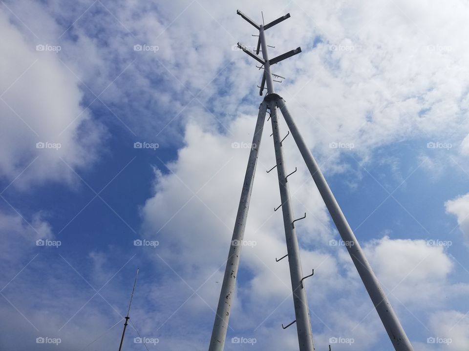 Antenna and blue sky with clouds