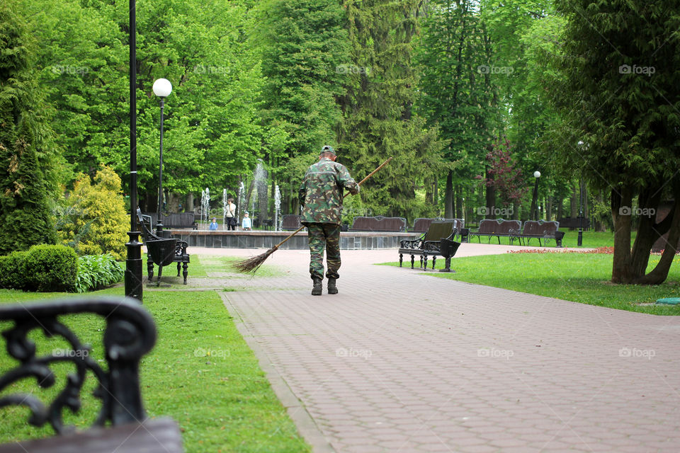 Janitor, worker, janitor sweeping the road, park, city park, nature, trees, grass, flowers