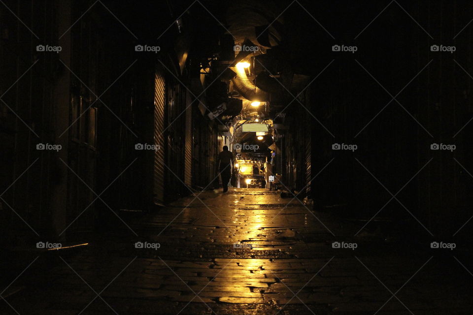 Man walking through jerusalem streets at night