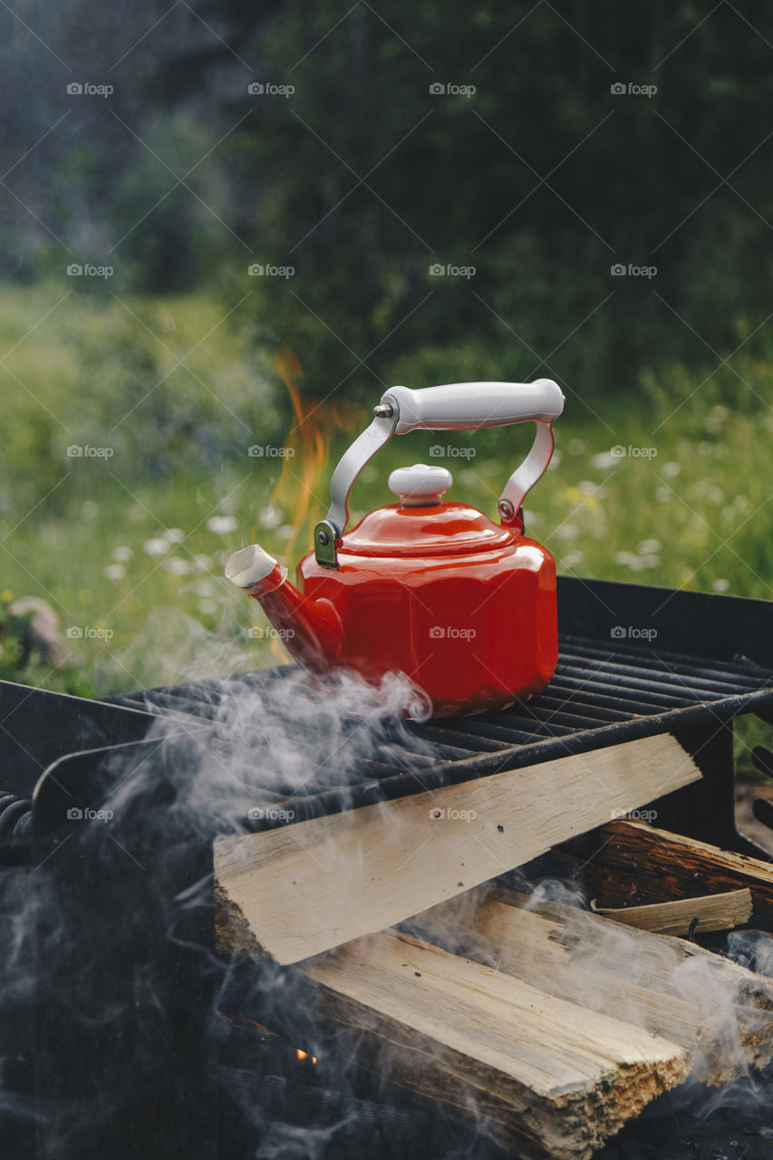 Heating up water for coffee in a red kettle 