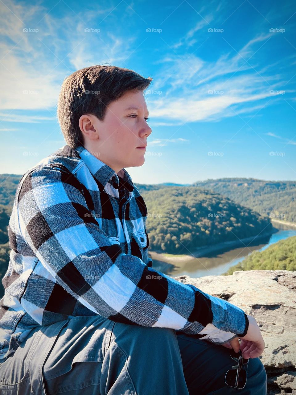 A handsome young man looking out over the river