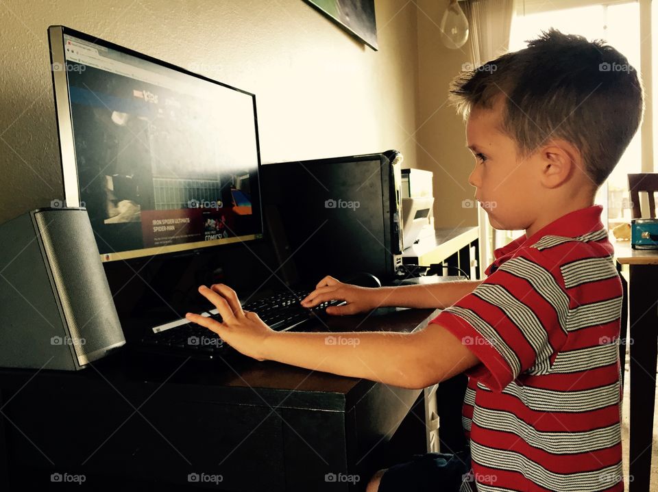 A little boy playing game in desktop