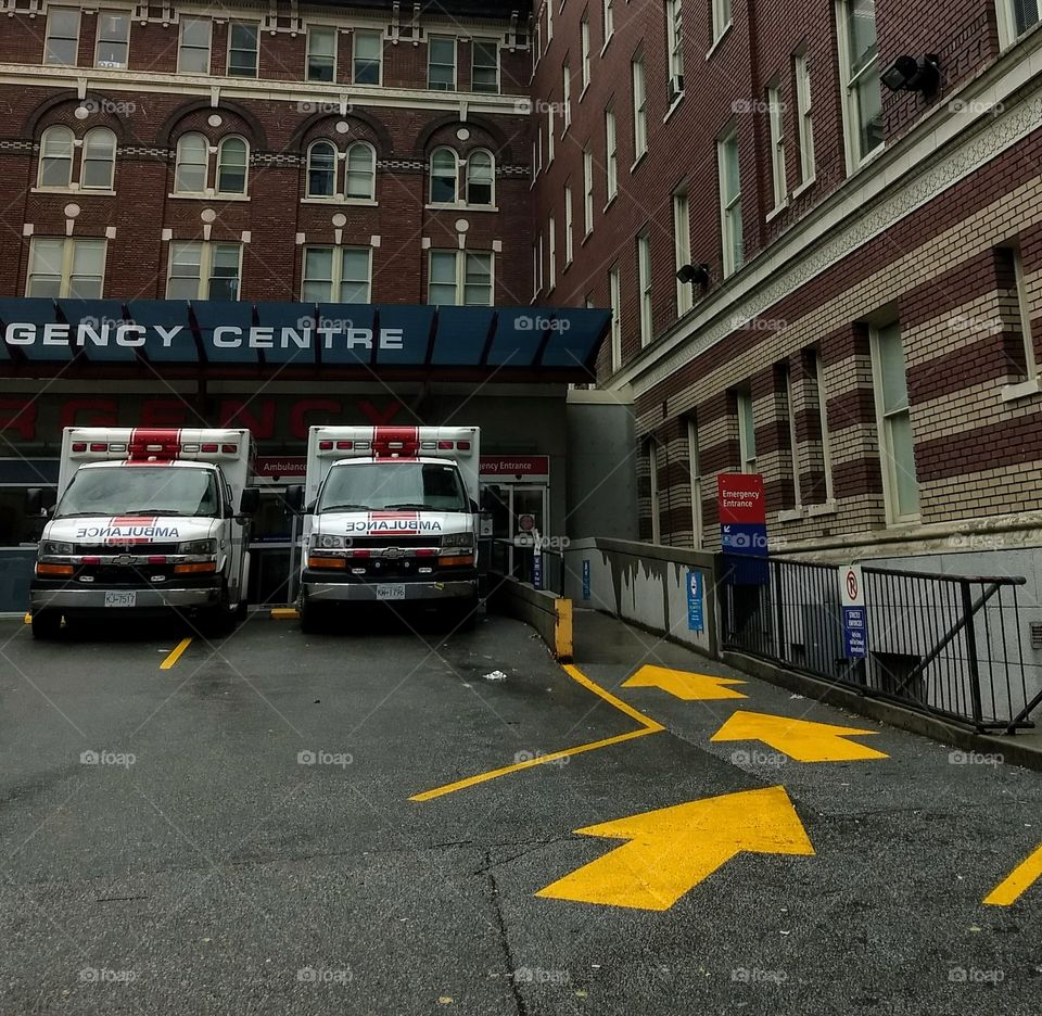 Parked ambulances wait to be driven outside a hospital emergency center.