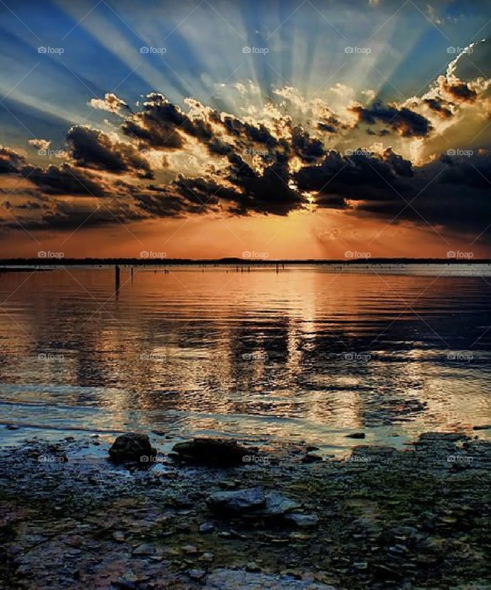 A sunset is the sun's fiery kiss to the night. 