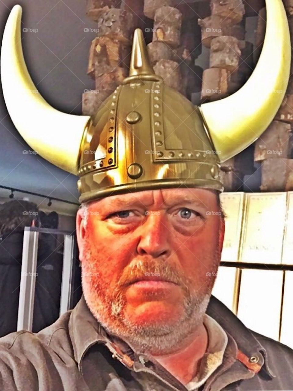 Man wearing Viking hat. Mean. Europe.