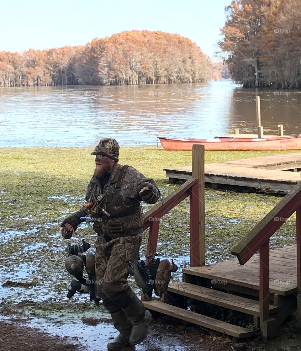 Duck Hunter with decoys on Caddo Lake Texas in the Fall