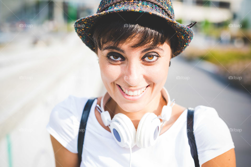 young beautiful woman looking camera smiling with headphones
