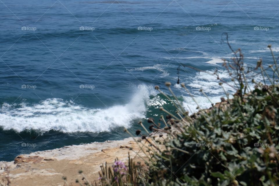 Waves crashing on  small a beach