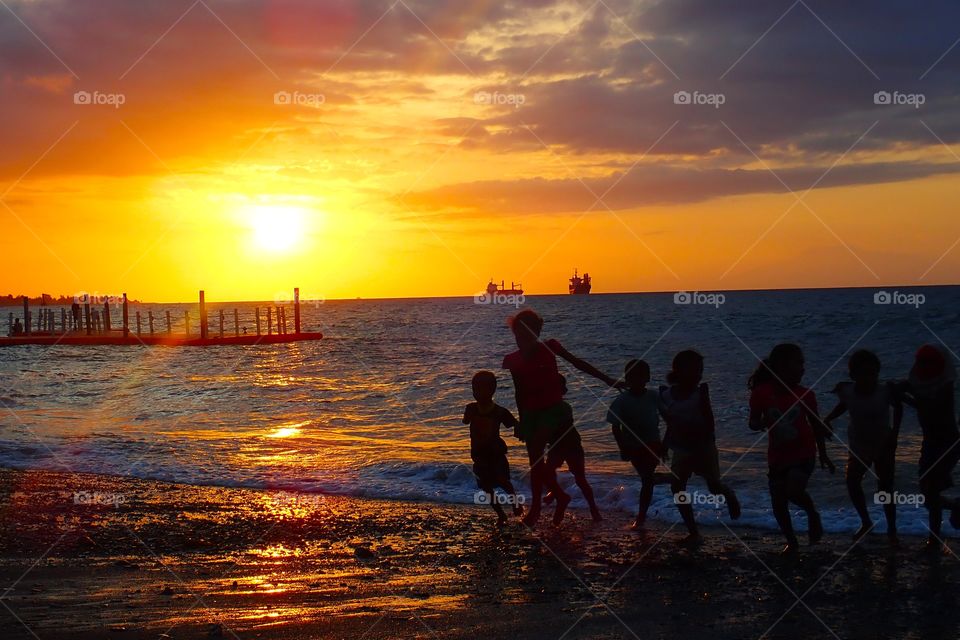 When children and humans are united and enlightened by the sun by the beach, it's a very close feeling to fulfillment!