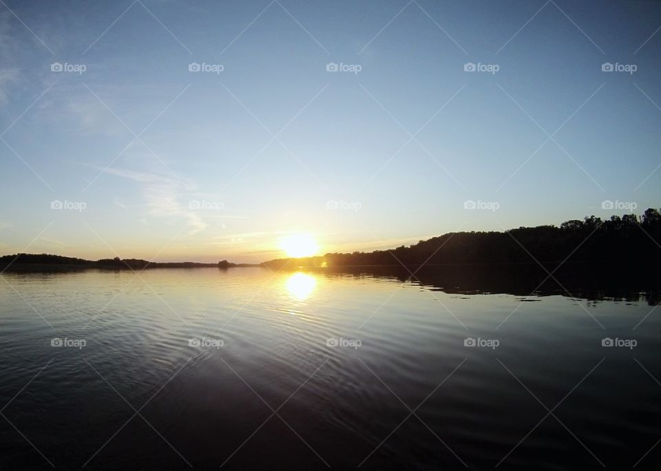 Sunset on Potomac. lines of wake during sunset